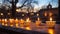 A scenic Hanukkah menorah lighting ceremony takes place outdoors, against the backdrop of a historic synagogue. The candles,