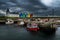 Scenic Harbor With Fishing Boats And Colorful Apartment Houses At John o`Groats In Scotland