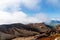 Scenic high angle view on Aso town, walk way from crater of active volcano Aso, mountains and abandoned old cable car building