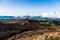 Scenic high angle view on Aso town, walk way from crater of active volcano Aso, mountains and abandoned old cable car building