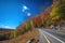 scenic highway in autumn, with colorful leaves and clear blue skies