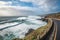 scenic highway with view of crashing waves and the sea