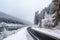 scenic highway in winter, with snow-covered trees and frozen lakes