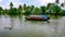 Scenic Houseboat on the backwaters during monsoon in Alleppey, Kerala, India.