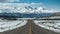 Scenic journey road leads toward majestic snowy mountain vista