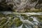 Scenic karst river Rak dissapearing in the cave system in national park Rakov Skocjan in Slovenia