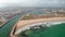 Scenic Lagos beach coast in Algarve, Portugal. Aerial drone view flying backwards above ocean with Portuguese townscape