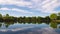 Scenic Lake with Cloud Reflections Zoom Out Timelapse