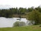 A scenic lake with moss covered shoreline in the Lake District