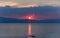 Scenic lake with silhouette of boat against mountains at sunset, Ohrid Lake, Macedonia