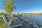 Scenic lake view with bench on the shore overlooking buildings and mountain