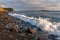 Scenic landscape of Black Sea coast by Bolshoy Utrish village, Anapa, Russia. Wave splashing on pebble beach at sunset