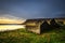 Scenic landscape including ruined house, typical cliffs and a lake in Iceland