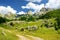 Scenic landscape of mountain valley in european Alps. Road goes into the distance. Stunning view of mountains and valleys in