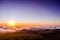 Scenic landscape in the mountains during sunset. View from above the clouds. Mountain in clouds with sunset. Viewpoint hiking