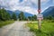 Scenic landscape of Pkhiya village in Caucasus Mountains with road sign and navigation to Kislyie Springs - popular tourist