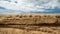 Scenic landscape. Sandy shore. Sand rock. Cloudy sky