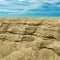 Scenic landscape. Sandy shore. Sand rock. Cloudy sky