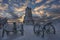 Scenic landscape shot at sunrise with ancient guns covered with snow