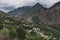 Scenic landscape of traditional tibetan village against mountains and dramatic cloudy sky