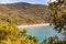 Scenic landscape view on Cala Violina sand beach and Tyrrhenian Sea bay surrounded by green forest in province of Grosseto in