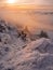 Scenic landscape with a view from a mounatin range to the valley filled with low clouds and fog during temperature inversion