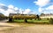 A scenic landscaped garden near the Church of the Hotel des Invalides and Eiffel tower on the background, Paris