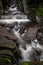 Scenic Long Exposed Waterfall In Forest Landscape In Scotland