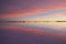 Scenic magic pink and purple sunset in bolivian salar Uyuni