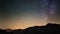 Scenic meteor explosion with stardust during time lapse of the Milky Way and the starry sky rotating over the Alps.