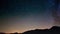 Scenic meteor explosion with stardust during time lapse of the Milky Way and the starry sky rotating over the Alps