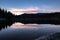 Scenic mirror reflection on fusine lakes in sunset, italy