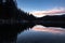 Scenic mirror reflection on fusine lakes in sunset, italy