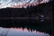 Scenic mirror reflection on fusine lakes in sunset, italy