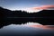 Scenic mirror reflection on fusine lakes in sunset, italy