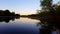 Scenic morning river scene in day. Riverside calm flowing canal water at dawn.