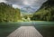 Scenic mountain lake plansarsko view with wooden footbridge in long exposure, slovenia