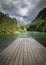 Scenic mountain lake plansarsko view with wooden footbridge in long exposure, slovenia