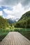 Scenic mountain lake plansarsko view with wooden footbridge, slovenia