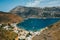 Scenic mountains and blue sea port with sailing boats in Porto Kagio, Mani, Greece
