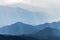 Scenic mountains range covered by soft fog