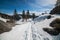 Scenic nature mountain view hiking trail under snow at winter time.