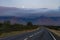 Scenic night landscape with beautiful road, moon and mountains from Iceland Westfjord