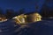 Scenic night photo of typical Swedish wooden mountain cabin with stars above, much snow, birch forest. Joesjo village, Lappland,