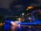 Scenic nightscape of Murinsel bridge on River Mur and illuminated castle in Graz, Austria