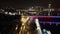 Scenic nighttime view of Belgrade Branko bridge over water, with cars seen driving across