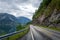 Scenic norwegian road between fjord water and steep mountain