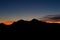 Scenic orange sunset in trentino with mountain silhuette at blu hour