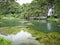 Scenic overgrown pond under the mountain with the jungle, in cloudy weather, Phang Nga, Thailand