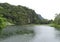 Scenic overgrown pond under the mountain with the jungle, in cloudy weather, Phang Nga, Thailand